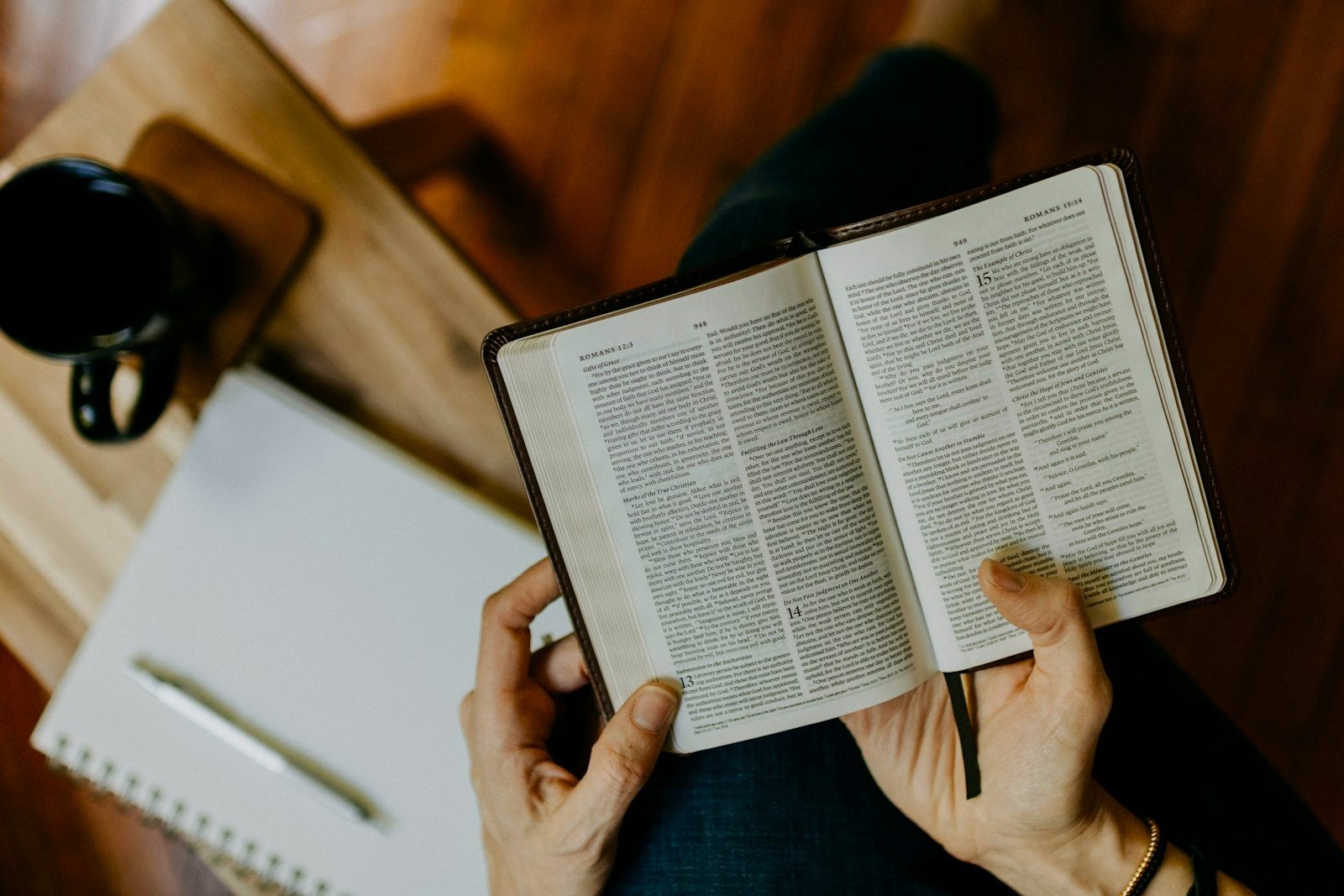 An open Bible and notebook on a table